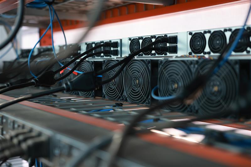 Bitcoin mining hardware with cooling fans and network cables