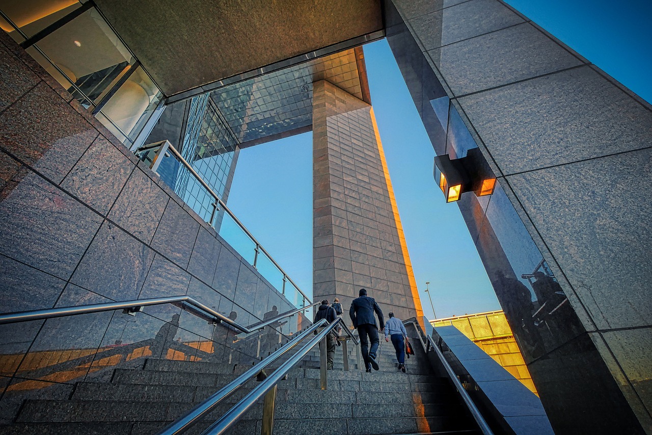 Professionals walking up stairs at a modern office building